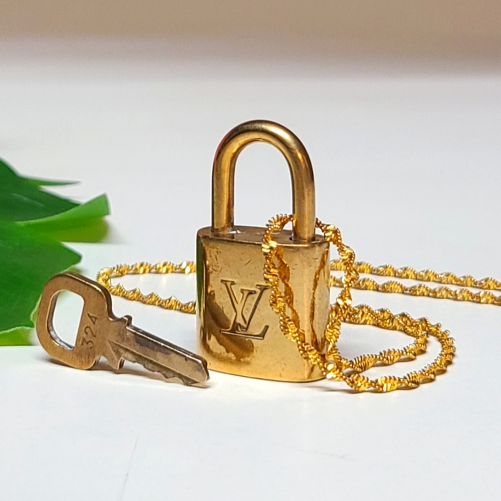 Louis Vuitton lock & key #324 with two 18k gp necklaces